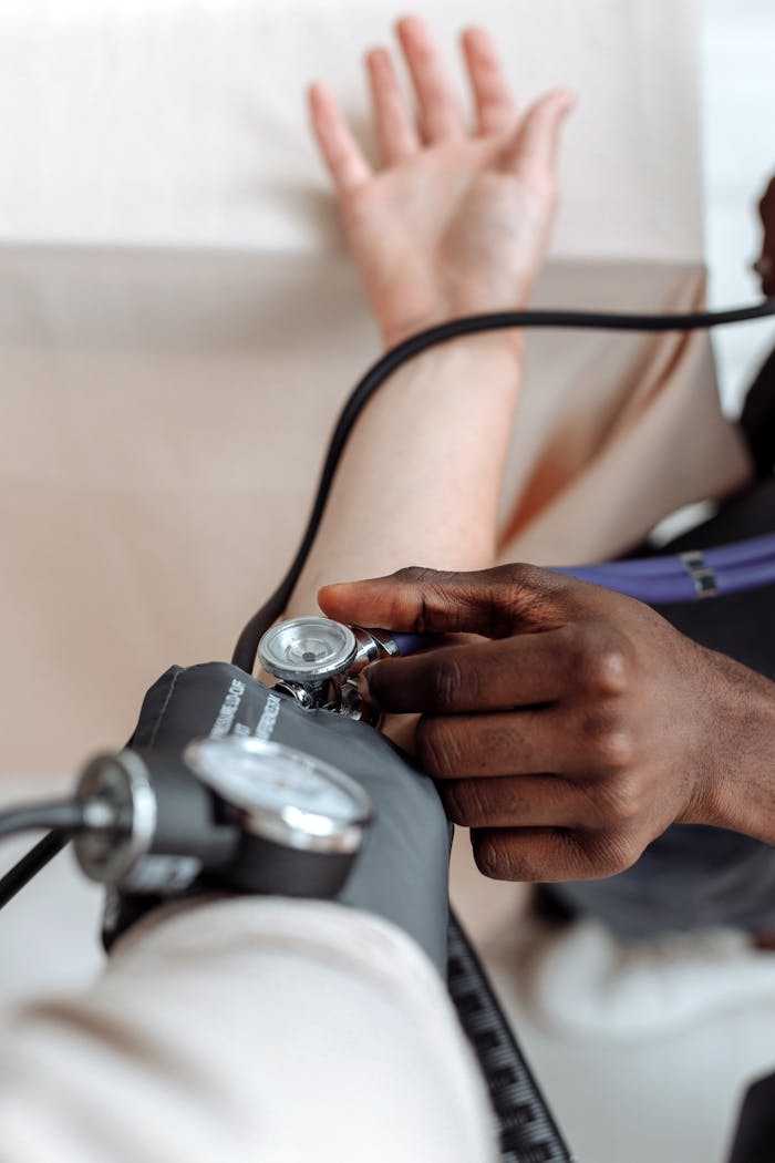 about-bg Close-up of a healthcare professional measuring a patient's blood pressure for a medical check-up.
